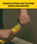 Hands opening a tube of sealant for sealing electrical sockets, with yellow label, in a home setting.