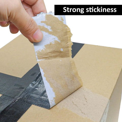 Close-up of Five Roll Pack Black Duct Tape Rolls For DIY Projects being peeled off a cardboard box, showing strong stickiness.