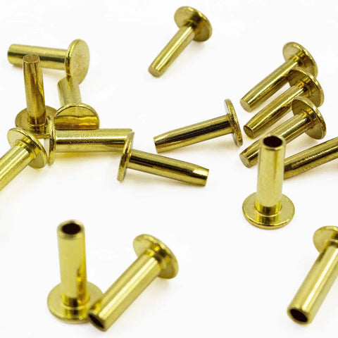 Brass Knife Handle Rivets 25 Piece Set for Knife Making High Strength 5/16 by 1/2 Inch Pins scattered on white background