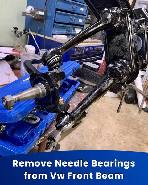 Tool setup for removing needle bearings from VW front beam in a workshop setting.