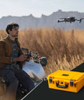 Man operating drone near yellow Waterproof PVC1 Hard Camera Case With Padded Dividers For Cameras Lenses And Dual Drones