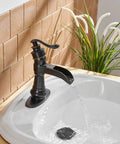 Oil Rubbed Bronze Waterfall Bathroom Sink Faucet With Single Handle 1 Hole Mount in use with water flow in a farmhouse vanity.