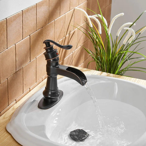 Oil Rubbed Bronze Waterfall Bathroom Sink Faucet With Single Handle 1 Hole Mount in use with water flow in a farmhouse vanity.