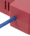 Close-up of Automatic Fire Extinguishing Device Dual Line Aerosol module with blue wire, designed for car fire suppression.