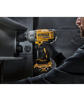 Man using 20V Max Cordless Impact Wrench With Hog Ring Anvil, Brushless High Torque Half Inch in industrial setting.