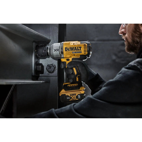 Man using 20V Max Cordless Impact Wrench With Hog Ring Anvil, Brushless High Torque Half Inch in industrial setting.