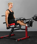 Leg Extension And Curl Machine For Home Gym, Heavy Duty 550 Pounds Load; user in workout posture; red and black frame.