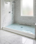 Bathroom shower with 3 Inch Tall Collapsible Shower Threshold Dam, 39 Inch Long Water Splash Guard Barrier preventing overflow.