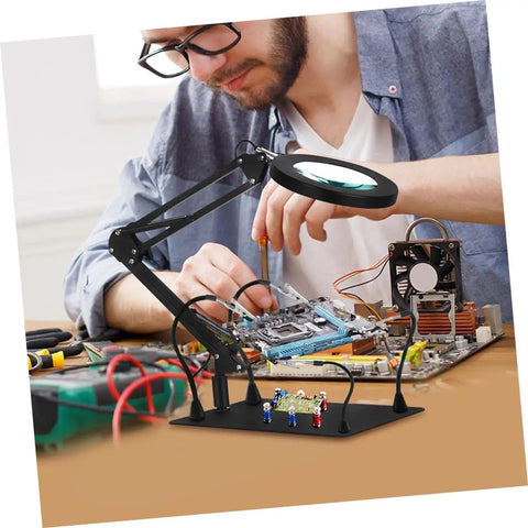 Person using Alligator Clamp Soldering Helper Set With Magnifying Glass Lamp Secure Workholding Tool for circuit board repair.