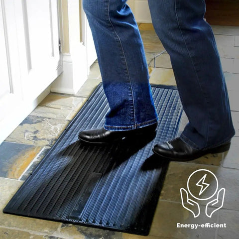 Person standing on Foot Warmer Portable Heated Rubber Mat For Home Office Garage And Car 135W Energy Saving Warmth, Waterproof Black