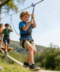 Child using Heavy Duty Zip Line Trolley With Quick Setup Rope Slider For Slack Line And Outdoor Play For Ages Five And Up