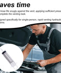Mechanic using Brake Bleeder Kit With Syringe Hose And Tubing For Motorcycle And Car Maintenance next to open car hood