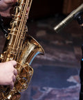Pro Grade Condenser Mic With Windscreen Cardioid XLR Studio Recording Mic beside saxophone during performance