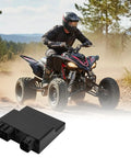 Pro Grade CDI Box Replacement For Yamaha YFZ 450 And Honda ATVs, shown in foreground with rider in background