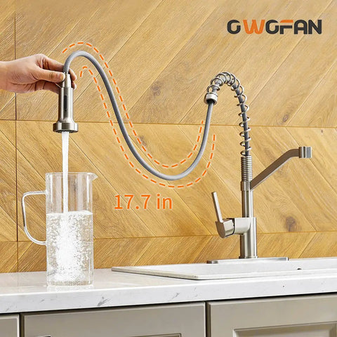 Brushed Nickel Kitchen Faucet With Pull Down Sprayer, Single Handle, showing water flowing into a pitcher on a countertop