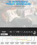 Close-up of guitar pedalboard with built-in power supply ports and guitarist playing in the background.