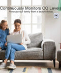 Woman and child on sofa with laptop, wall-mounted Three Pack Carbon Monoxide Detectors With Digital Display Battery Operated CO Alarm visible