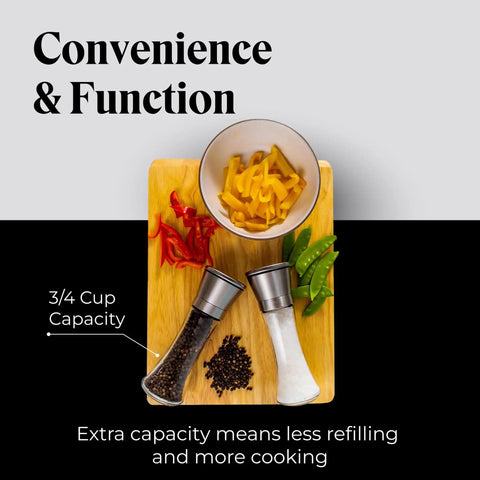 Top view of the Must-Have Salt and Pepper Grinder Set With Stand, Glass Body Grinders with vegetables and dishes on a board.