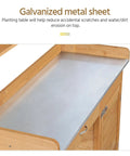 Close-up of metal tabletop on outdoor garden potting bench with wood tabletop and open shelf cabinet drawer dope fir wood workstation for potting plants herbs veggies and DIY garden projects.