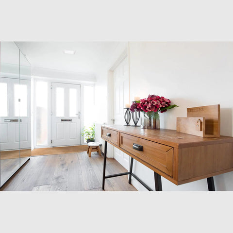Square Recessed Ceiling Light Trim With Glass Albalite Lens in a bright hallway with wood console and decorative items.