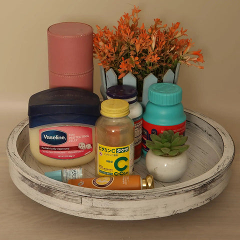 14 Inch White Distressed Round Lazy Susan Real Deal Farmhouse Turntable Smooth Spinning Wooden Serving Tray with various items.