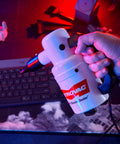 Hand holding Powerful Computer Duster and Cleaner for Electronics and Home Use, high velocity air blower near keyboard.