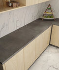 Charcoal Concrete Wallpaper Peel And Stick 3D Thick Faux Cement Contact Paper Vinyl Wrap For Walls, shown on a kitchen surface.