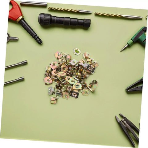 Premium Gold U Shaped Automotive Fasteners 50 Piece Set Replacement Panel Mounting Clips on green surface with tools.
