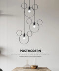 Cartoon Mouse Pendant Light Three Head Iron Chandelier for Kids Room with black metal finish in a dining area.