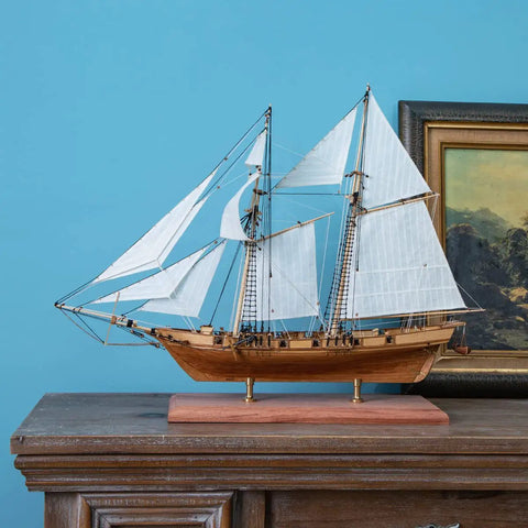 Scale model of Harvey 1847 wooden ship with sails, displayed on cabinet; Wooden Ship Model Kit for Grownups One Ninety Six Scale.