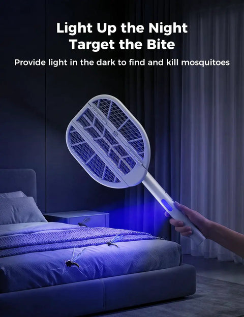 Foldable Electric Fly Swatter Racket with 4000V High Voltage in use with blue light in a dimly lit bedroom setting.
