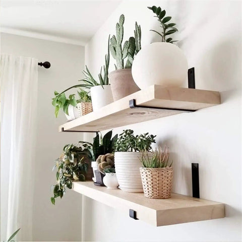 Knockout Heavy Duty Shelf Brackets For Floating Shelves Built Like A Tank With Solid As A Rock Iron Design Slick Industrial Wall Mount Brackets Black holding wooden shelves with potted plants.