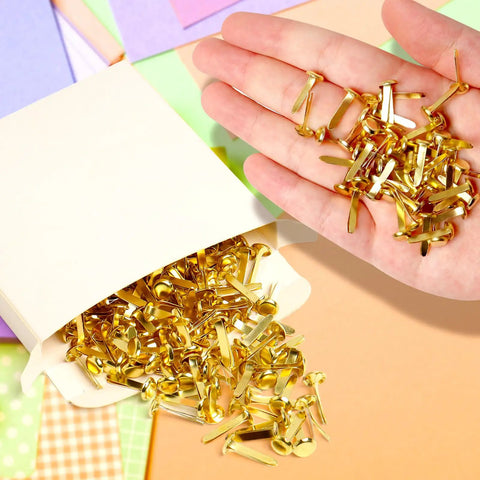 High Quality Brass Paper Fasteners 3/4 Inch Round Metal Brads in hand with colorful craft papers, 300 Count Pack, perfect for DIY projects.