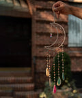 Hand holding a crescent moon dream catcher with colorful beads, part of 8 Pcs Metal Moon Frame Hoops In Four Sizes For Dream Catchers Crescent Wreaths And Macrame Craft Projects Durable Wire Rings For DIY Home Wall Hangings Floral Crafts And Half Shape Decorations Must Have For DIY Enthusiasts