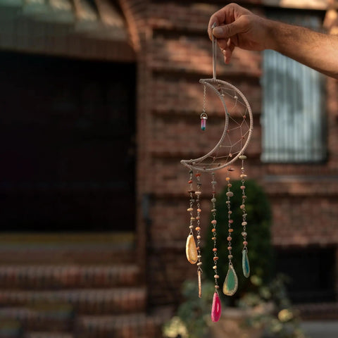 Hand holding a crescent moon dream catcher with colorful beads, part of 8 Pcs Metal Moon Frame Hoops In Four Sizes For Dream Catchers Crescent Wreaths And Macrame Craft Projects Durable Wire Rings For DIY Home Wall Hangings Floral Crafts And Half Shape Decorations Must Have For DIY Enthusiasts