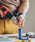 Person using drill with All In One Pocket Hole Jig Kit Pro Grade Heavy Duty Metal Pocket Screw Jig With 15 Degree Locator.