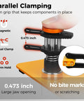 Close-up of magnetic dual clamp from All-In-One Helping Hands Soldering Station With 5X Magnifying Lamp holding orange surface