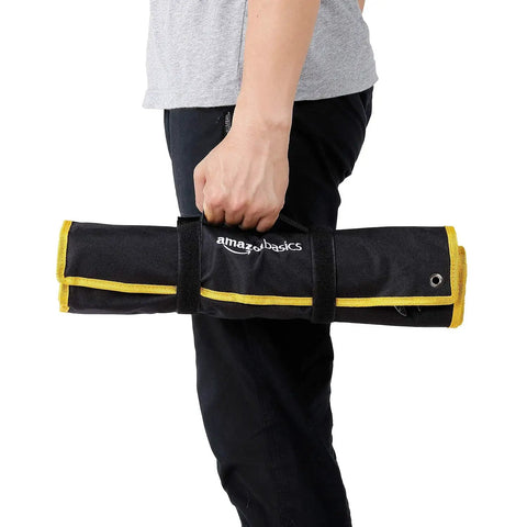 Person holding Angled Double Open End Wrench Set, 14-Piece Chrome Finish, in black and yellow nylon roll-up case, side view.