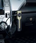 ArkPro Series Holster for Outdoor Adventures installed in vehicle holding flashlight with wall and vehicle mounts, visible cable attached.