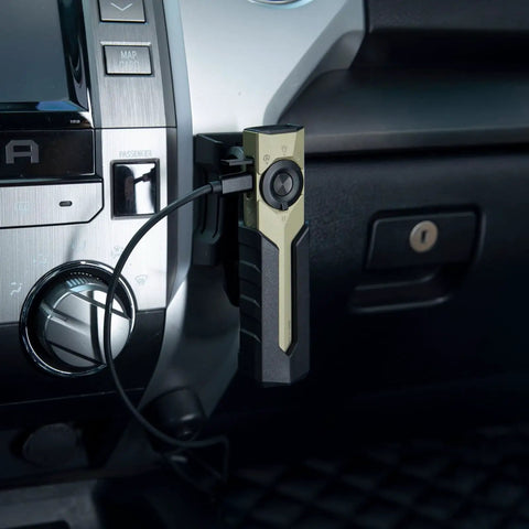 ArkPro Series Holster for Outdoor Adventures installed in vehicle holding flashlight with wall and vehicle mounts, visible cable attached.