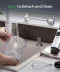 Pro Level 500W Immersion Hand Blender Kicked Up With 12 Variable Speed Settings Plus Turbo Boost Option And Reliable 4in 1 Kitchen Wand being cleaned with water.