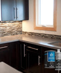 Rock Hard Concrete Countertop Sealer Semi Gloss Water Based Formula shown on modern kitchen countertop under natural light.