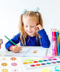 Girl in blue shirt using Retro Groovy Floral Name Tag Stickers with Daisy Flower Nameplates in a classroom setting.