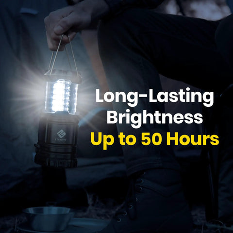 Person holding Four Pack LED Camping Lanterns For Power Outages And Emergencies with bright LED light illuminating a campsite.