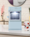 Portable Countertop Nugget Ice Maker Delivers Sick Chill Levels With Legit Chewable Snow Ice Ready Fast Features near a glass of ice.