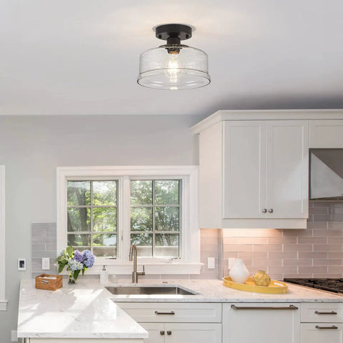 Semi Flush Mount Ceiling Light With Seeded Glass Shade in Black Finish in a modern kitchen setting.