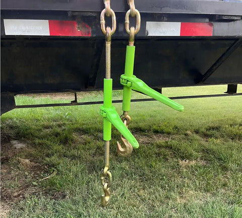 4 Pack 5/16 To 3/8 Inch Heavy Duty Hi Vis Green Ratchet Tie Down With Grab Hook And Slip Clip 5400 Lb working on flatbed trailer.