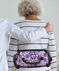 Anti Slip Gait Belt Transfer Strap For Seniors with floral pattern, shown on a patient assisted by a caregiver.