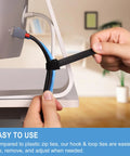 Person adjusting an Eight Inch Reusable Cable Ties With Hook And Loop Wraps for cord management at desk setup.
