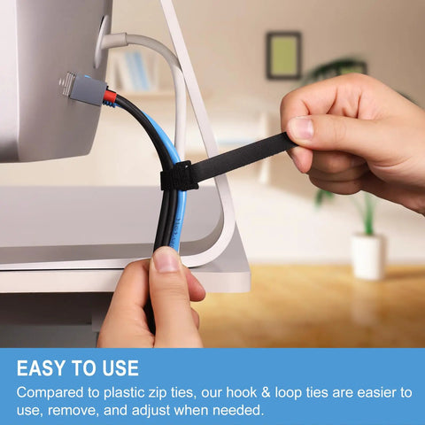 Person adjusting an Eight Inch Reusable Cable Ties With Hook And Loop Wraps for cord management at desk setup.
